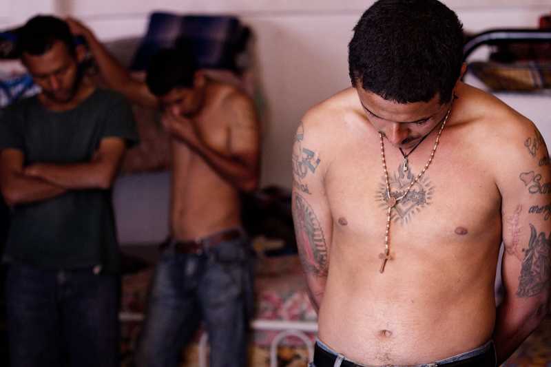 Immigrants from Central America bow their heads in prayer at a shelter outside Mexico City. Many of them are on their way to the United States. (Photo: Prometeo Lucero / CNN.com)
